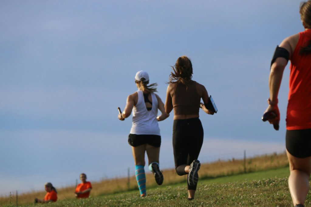 Runners wearing sportswear are exercising.